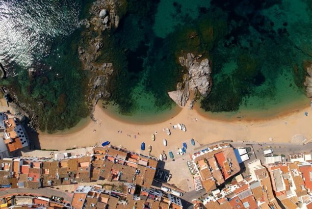 Aerial view of Costa Brava paradise beach in summer and people swimming in clear waters