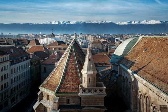 Aerial view of Geneva and St Pierre Cathedral with Alps Mountains - Geneva, Switzerland