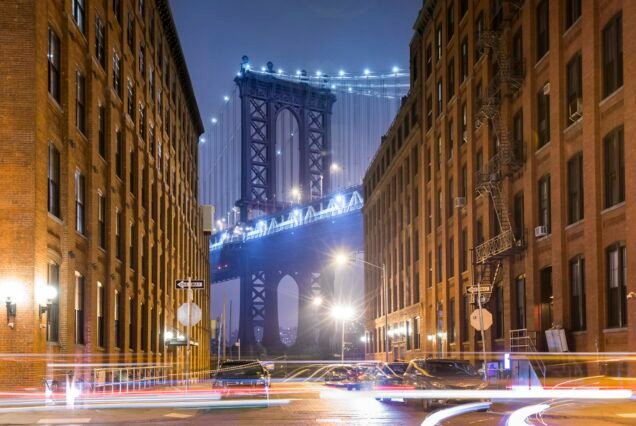 Manhattan Bridge and city apartments at night, New York, USA