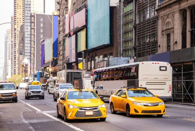 New York, streets. High buildings, colorful signs, cars and cabs