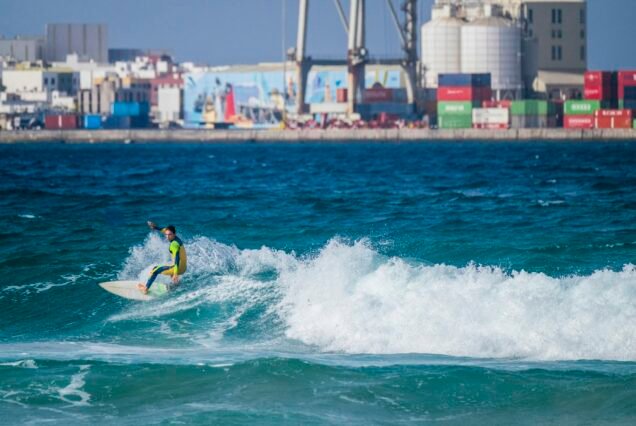 Surfer, going down a wave in Playa Blanca, Fuerteventura, Spain.