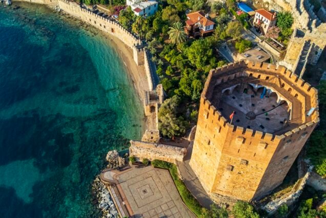 Tersane beach bay Alanya in Antalya Turkey. Sea and city with an open sky. Kizil Kule - Alanya