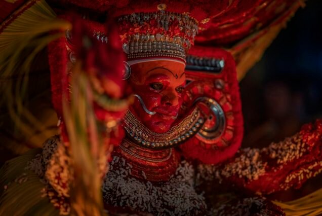 Indian man disguised as theyyam as part of ritual form of dance