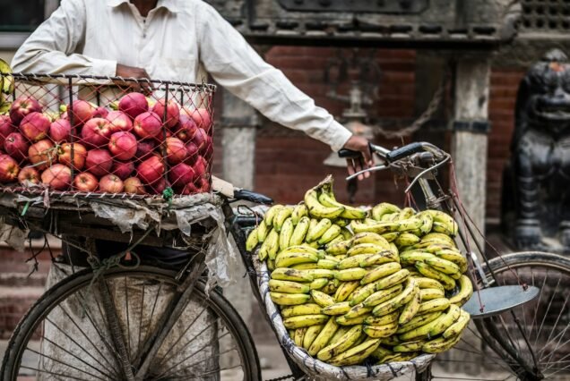 Man sells bananas and apples on a bike