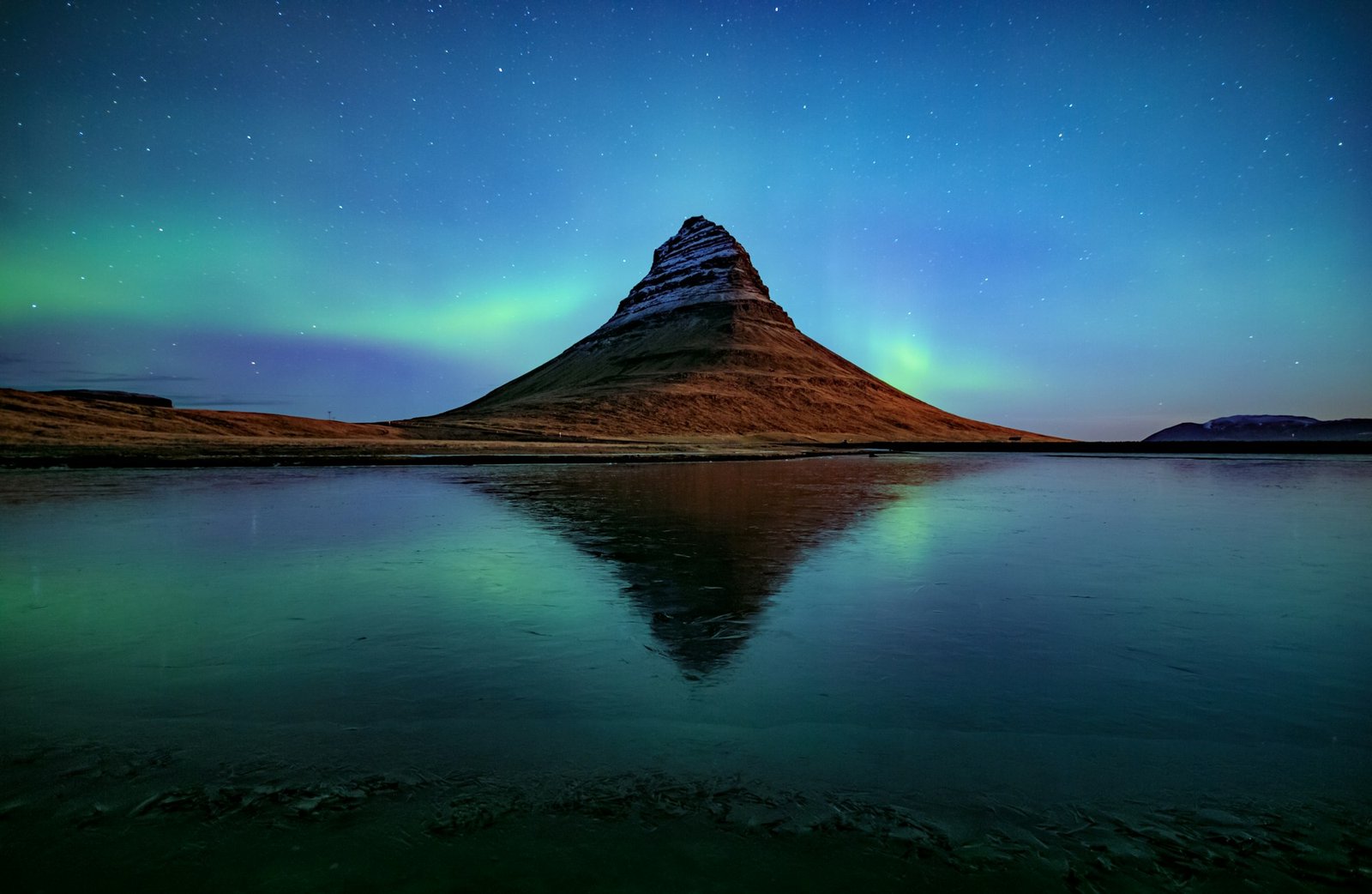 Northern light (Aurora Borealis) over Kirkjufell mountain in iceland
