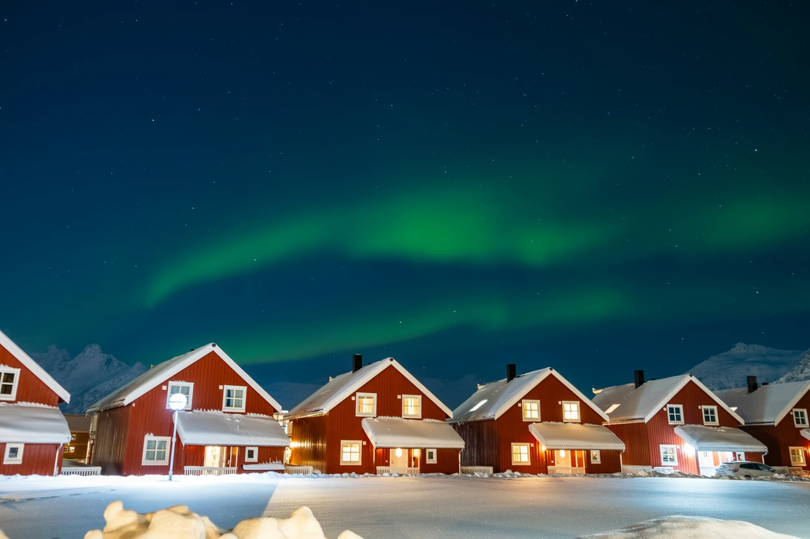 Northern lights over rorbu cabins in Svolvaer on Lofoten islands, Norway.