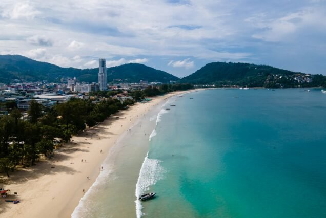 Patong beach Phuket, drone view of tropical beach with beach chairs and palm trees