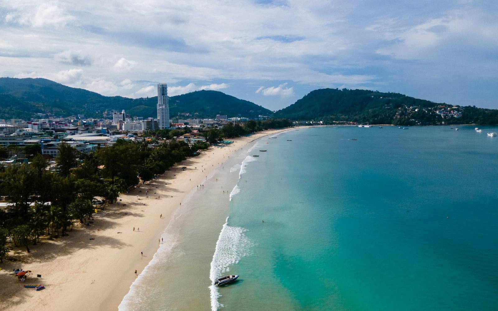 Patong beach Phuket, drone view of tropical beach with beach chairs and palm trees