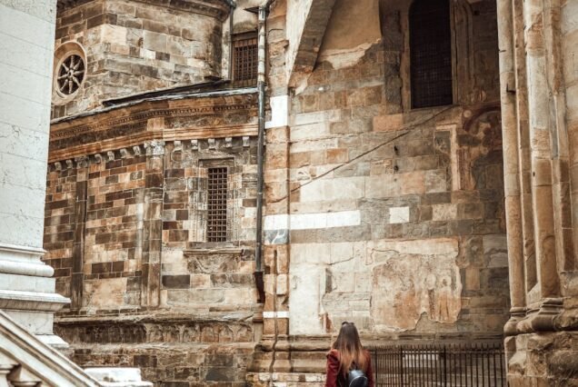 Young woman walking by Bologna Centre