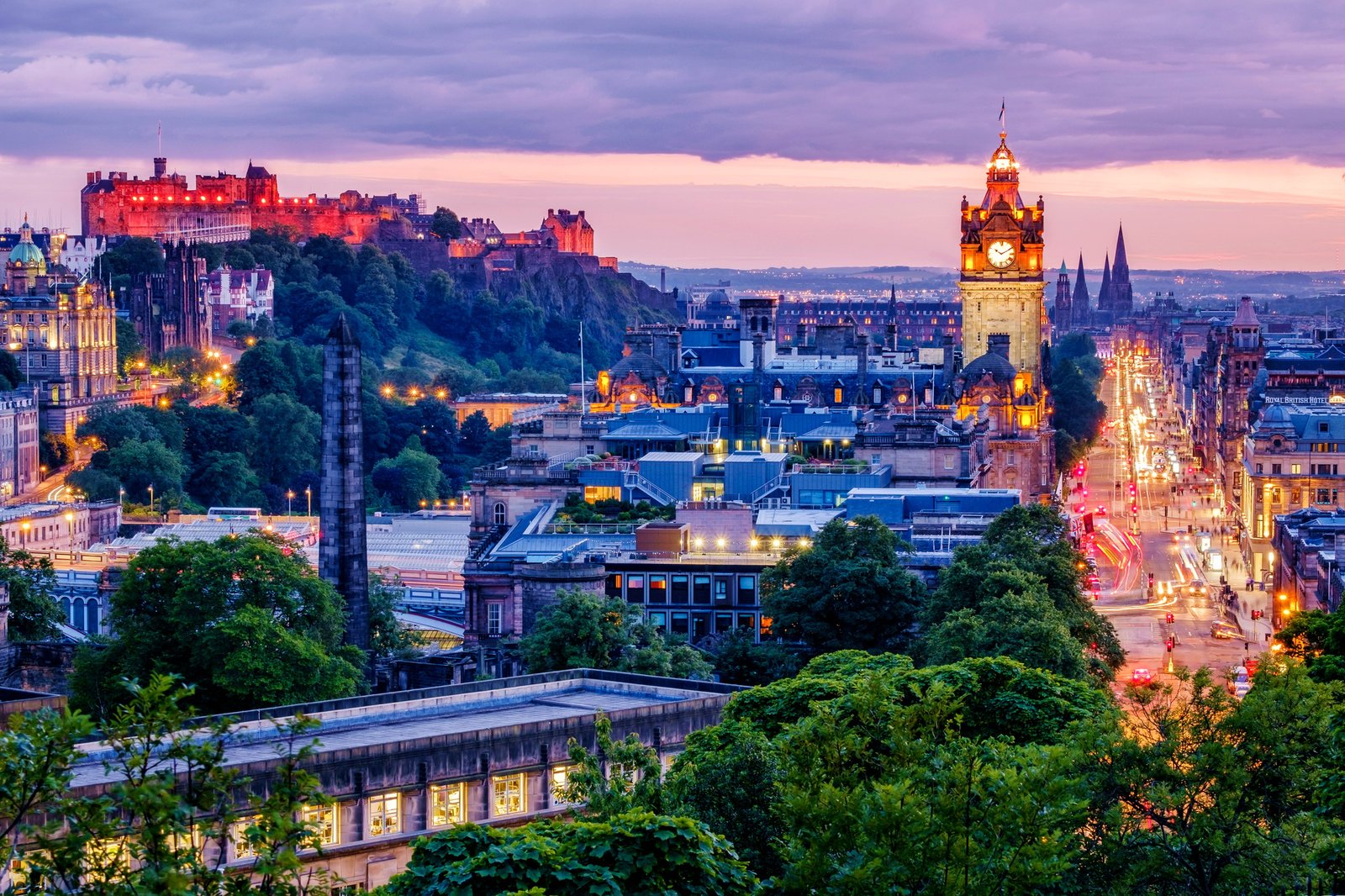 Edinburgh skyline lit up at dawn.
