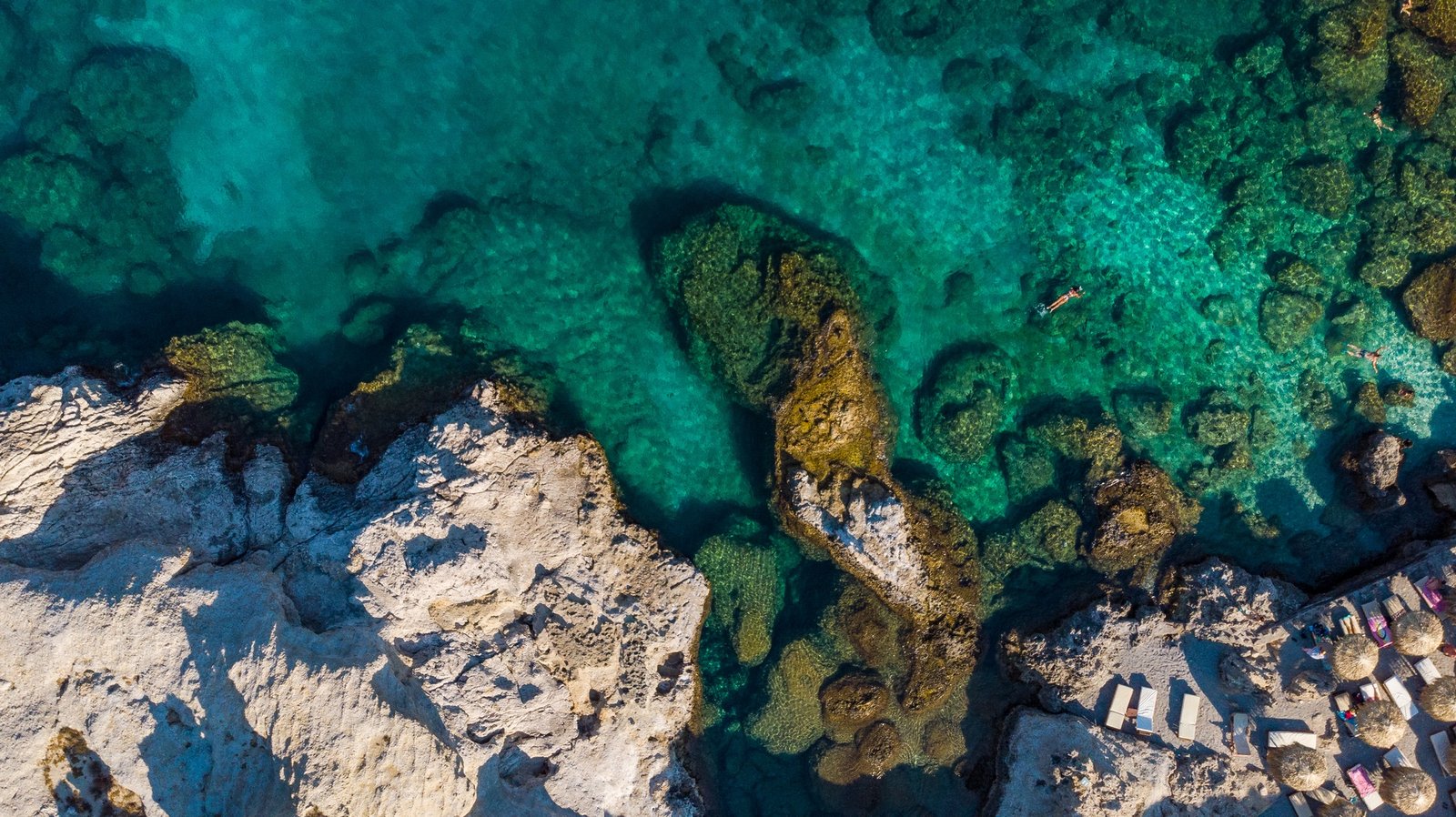 Turquoise Water and Rocky Shore on Greek Island, Aerial top Down